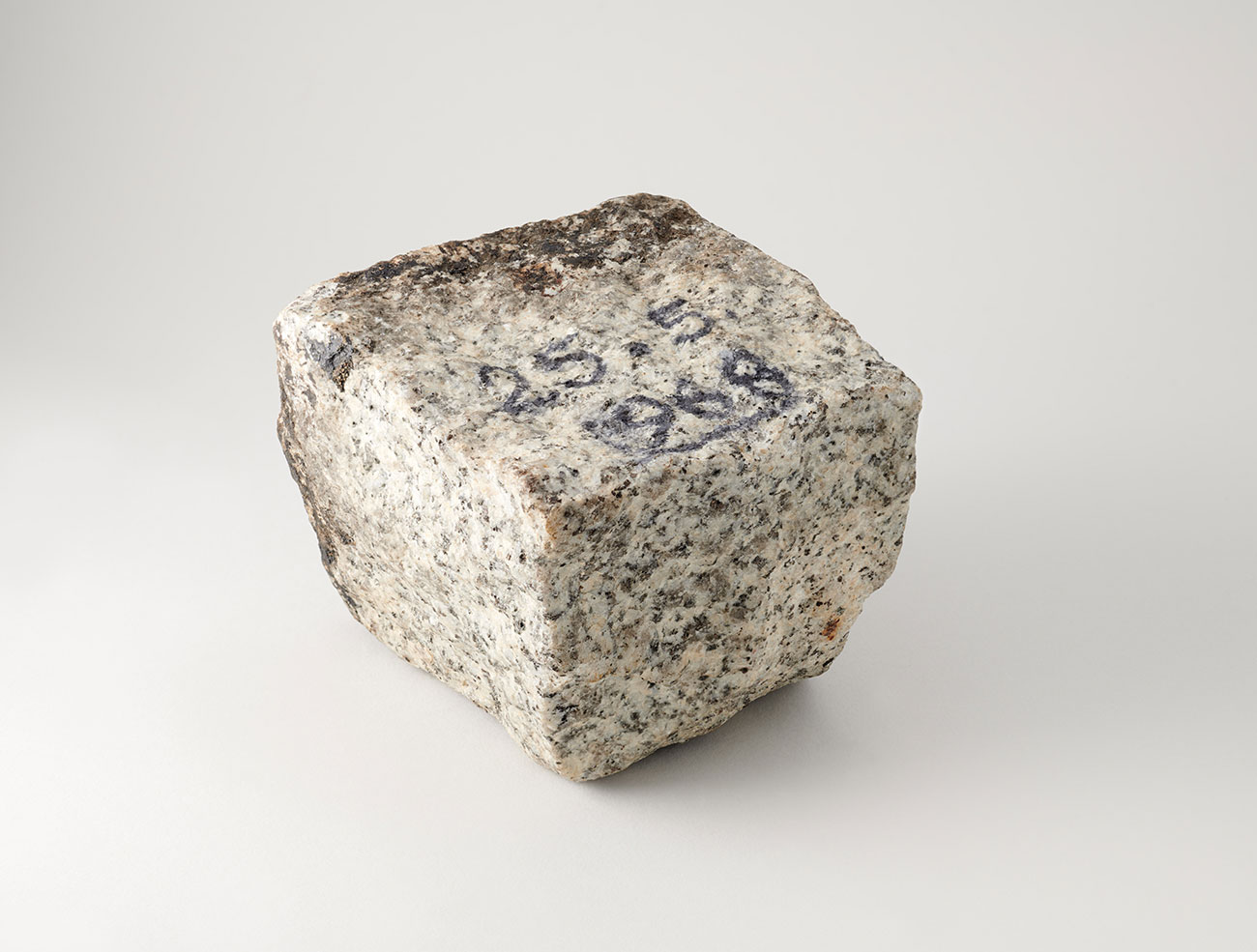 Pavé de Mai 68, granit taillé portant une inscription en noir « 25-5-1968 », Paris, fin du XXème siècle, 10,3 cm x 8,7 x 10,2 cm, 1,745 kg. Mucem, 1977.62.122, Don Rignaud, 1977 © Mucem / Marianne Kuhn